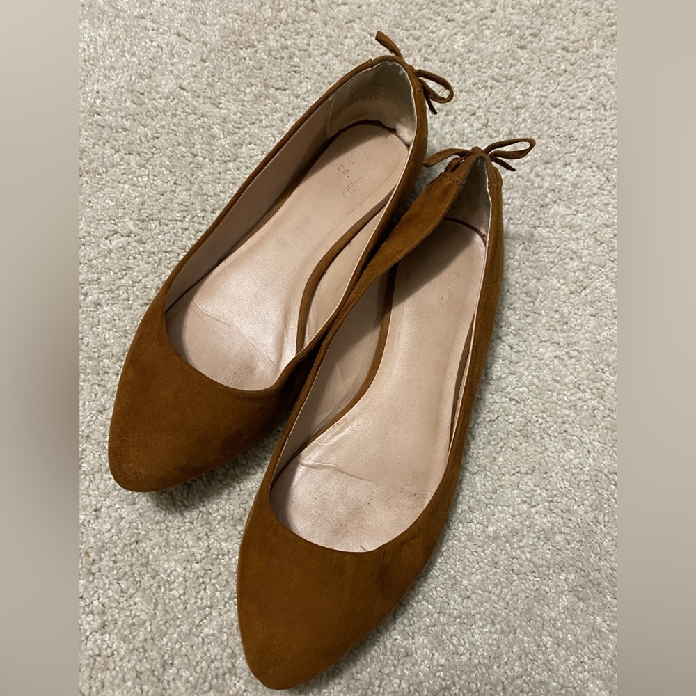 Brown suede flats with bow tie up  detail on back. Gently used. Size 8.5